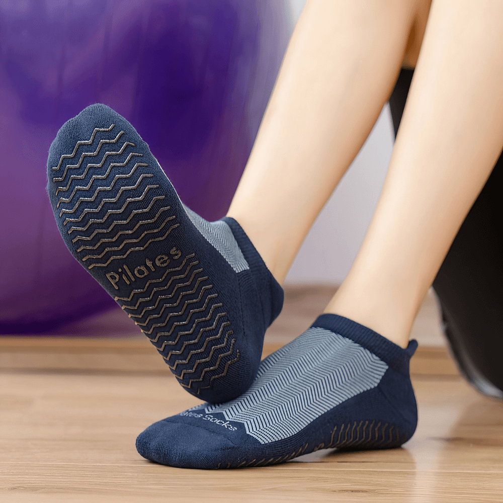 Woman wearing non-slip breathable pilates socks with grip sole, perfect for yoga, ballet, and fitness in trendy blue color.